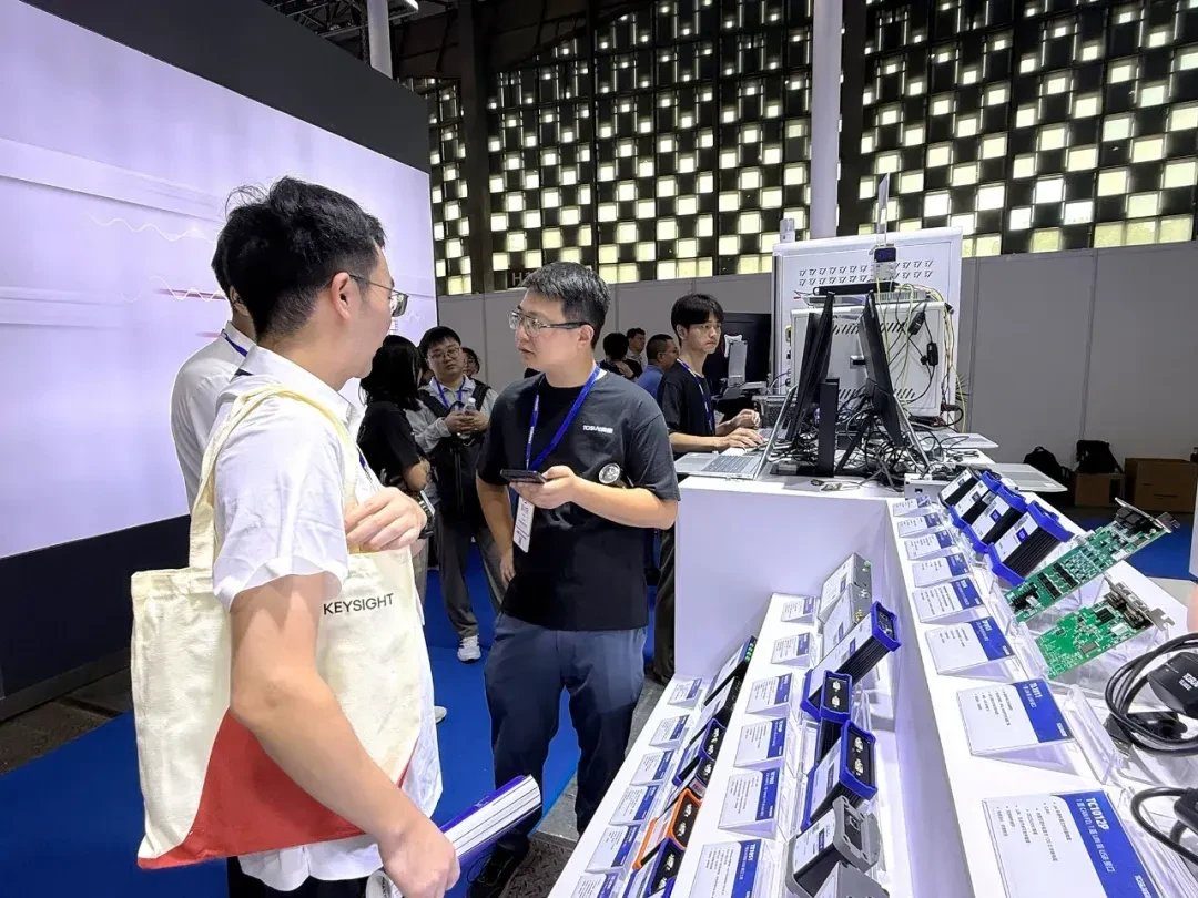 TOSUN booth visitor reviewing CAN FD hardware at Automotive Testing Expo China 2026
